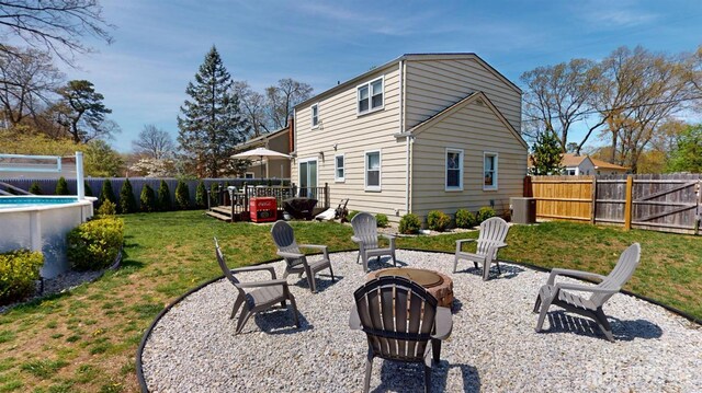 68 Applegate Ave, Monroe, NJ 08831 - rear view of property featuring a yard, a patio, a fenced backyard, a fenced in pool, and an outdoor fire pit