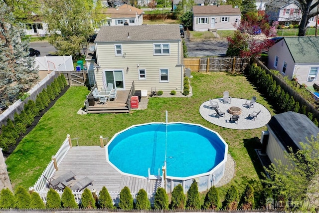 68 Applegate Ave, Monroe, NJ 08831 - view of swimming pool with a wooden deck, a gate, a fire pit, a residential view, and a patio area