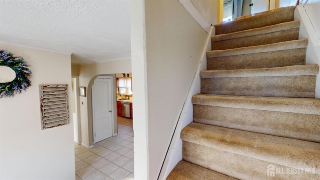 68 Applegate Ave, Monroe, NJ 08831 - stairs with arched walkways, tile patterned flooring, and a textured ceiling