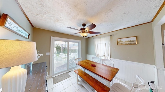 68 Applegate Ave, Monroe, NJ 08831 - dining room featuring wainscoting, a textured ceiling, ceiling fan, light tile patterned flooring, and crown molding