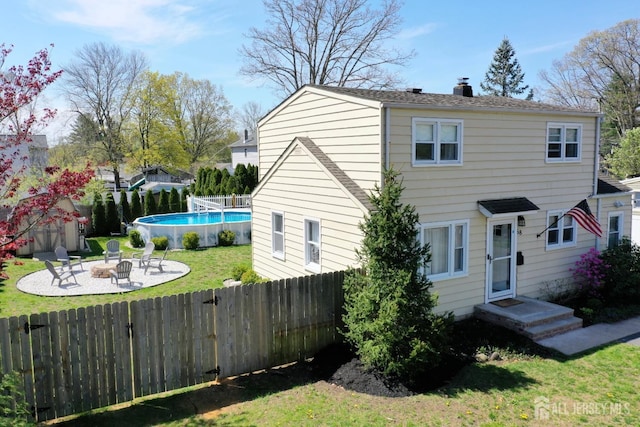 68 Applegate Ave, Monroe, NJ 08831 - view of front of home featuring a fire pit, a chimney, and a patio