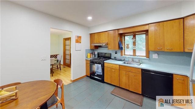 398 Waltham Ave, Metuchen, NJ 08840 - kitchen with black appliances, under cabinet range hood, light countertops, brown cabinetry, and recessed lighting