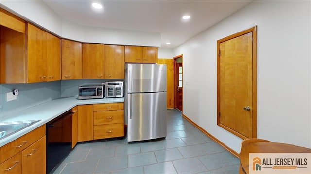 398 Waltham Ave, Metuchen, NJ 08840 - kitchen featuring appliances with stainless steel finishes, light countertops, brown cabinetry, recessed lighting, and dark tile patterned flooring