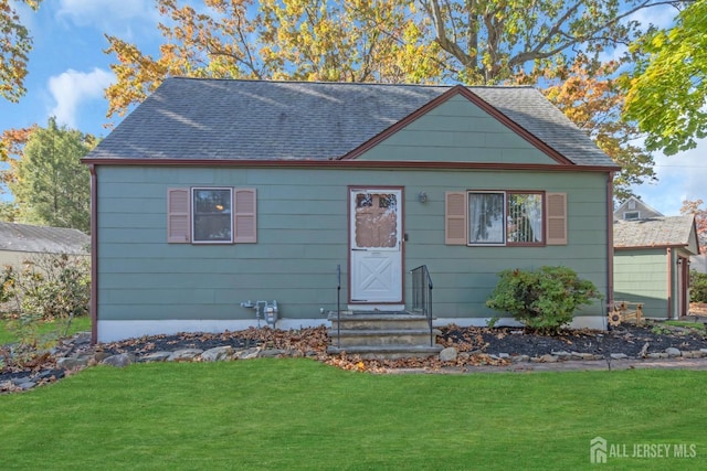 bungalow-style home with a front lawn