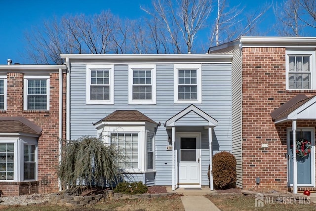 view of property with brick siding