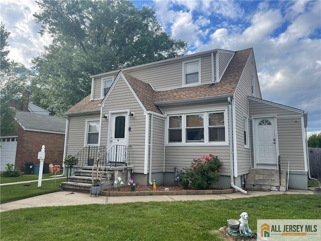 46 Pennsylvania Ave, Carteret, NJ 07008 - view of front of house with entry steps, roof with shingles, and a front yard