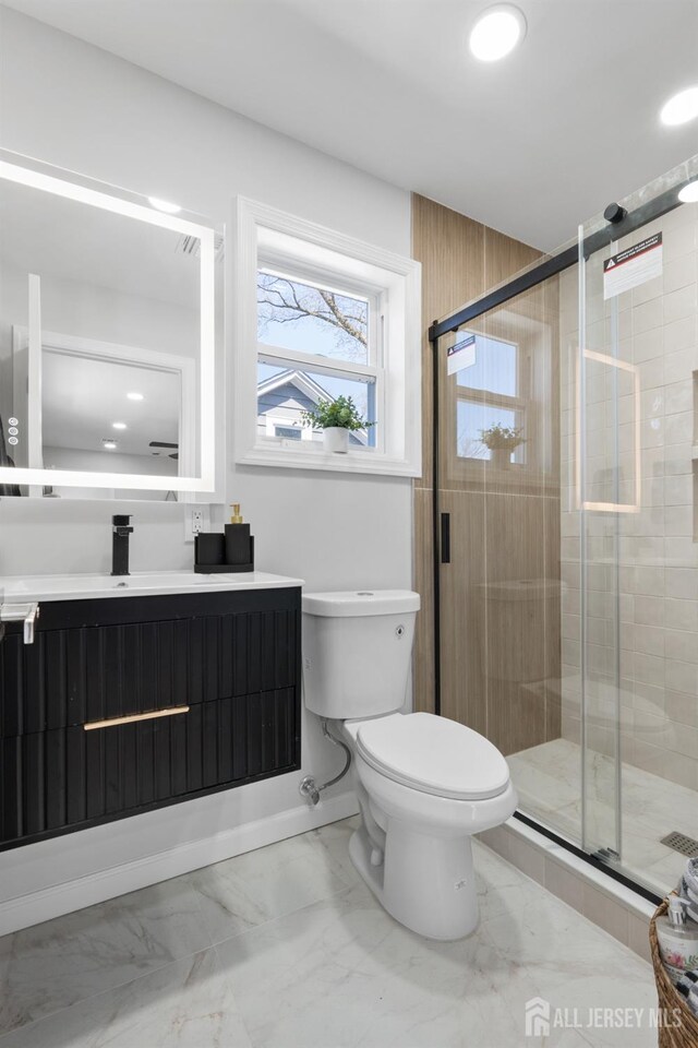 39 S Pierson Rd, Maplewood, NJ 07040 - bathroom featuring vanity, toilet, marble finish floors, a stall shower, and recessed lighting