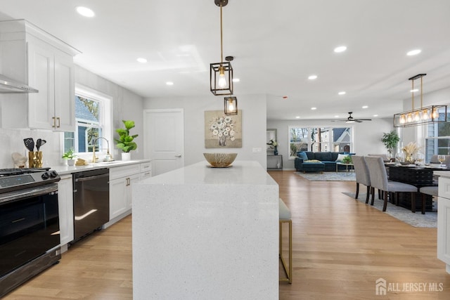 39 S Pierson Rd, Maplewood, NJ 07040 - kitchen featuring appliances with stainless steel finishes, a sink, light wood-type flooring, white cabinetry, and recessed lighting