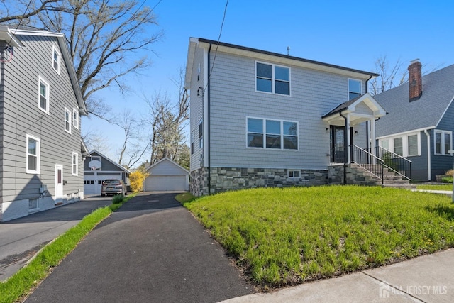 39 S Pierson Rd, Maplewood, NJ 07040 - view of front of house featuring an outbuilding, a detached garage, and a front yard