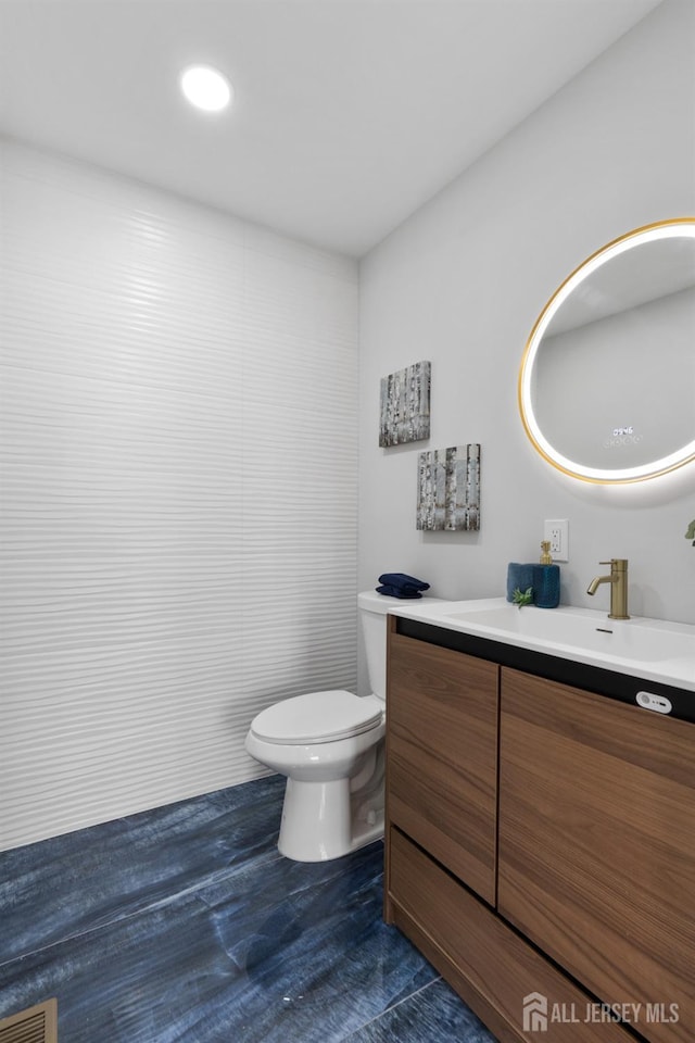 39 S Pierson Rd, Maplewood, NJ 07040 - half bathroom with vanity, toilet, and wood finished floors