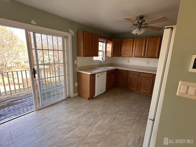 kitchen with ceiling fan, white dishwasher, and sink