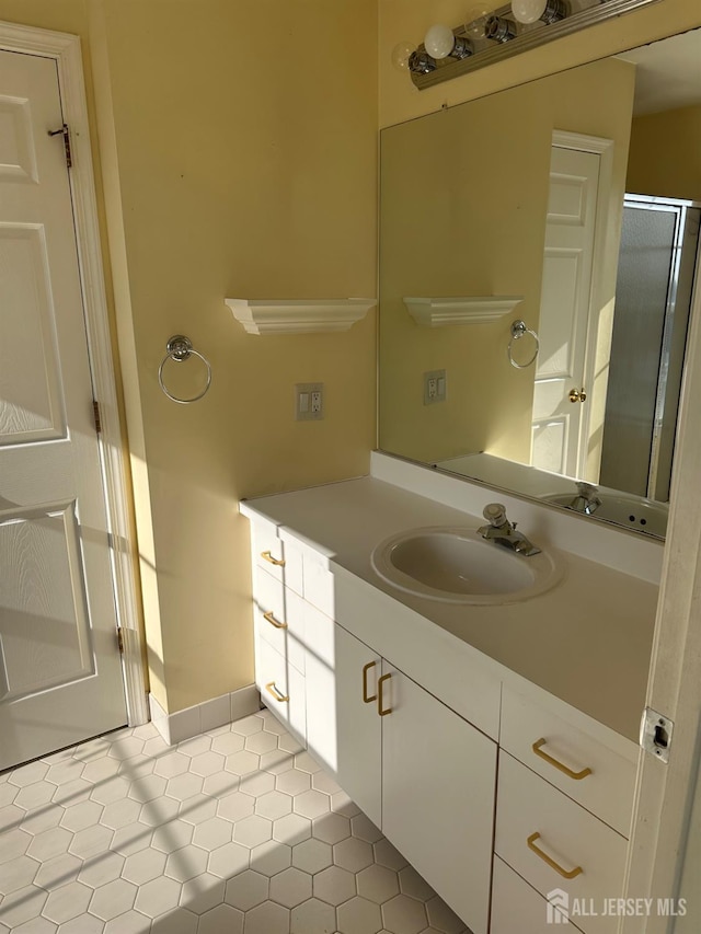 bathroom featuring tile patterned flooring, vanity, and an enclosed shower