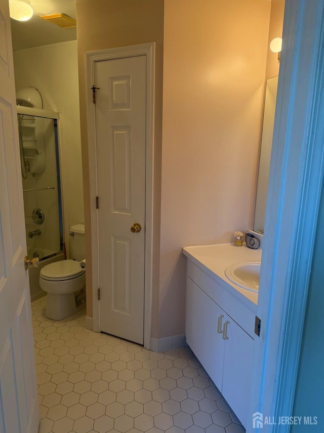 full bathroom with vanity, toilet, and combined bath / shower with glass door