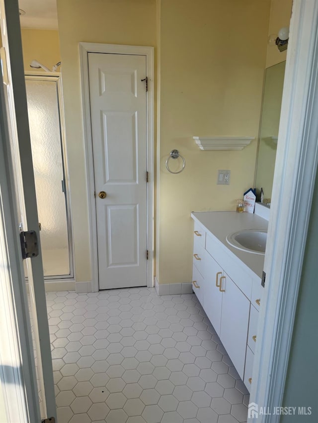 bathroom with vanity, tile patterned flooring, and a shower with door