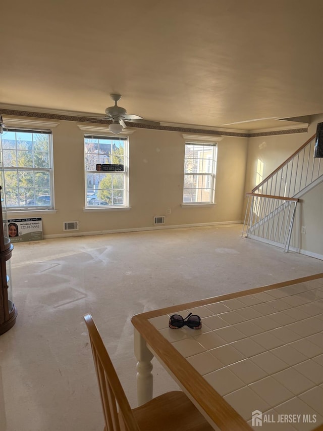 unfurnished living room with ceiling fan