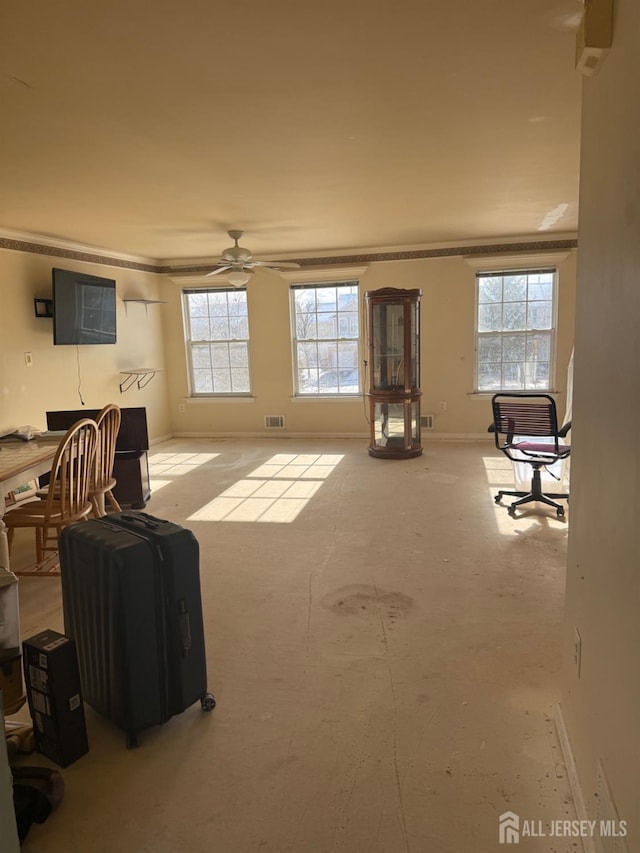 living room with ceiling fan, crown molding, and a healthy amount of sunlight