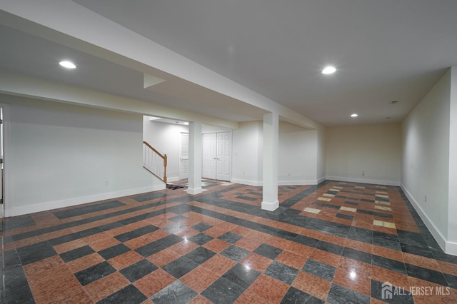 finished basement featuring granite finish floor, stairway, recessed lighting, and baseboards