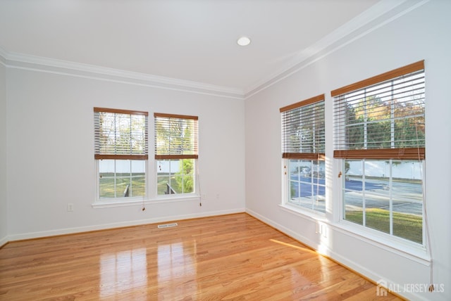 unfurnished room with light wood-type flooring, visible vents, ornamental molding, recessed lighting, and baseboards