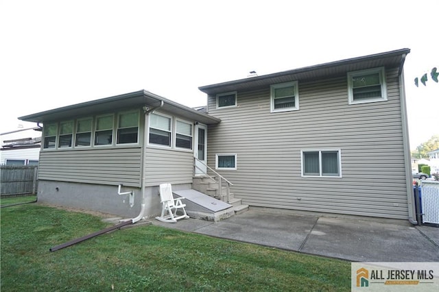 back of house featuring a patio area and a yard