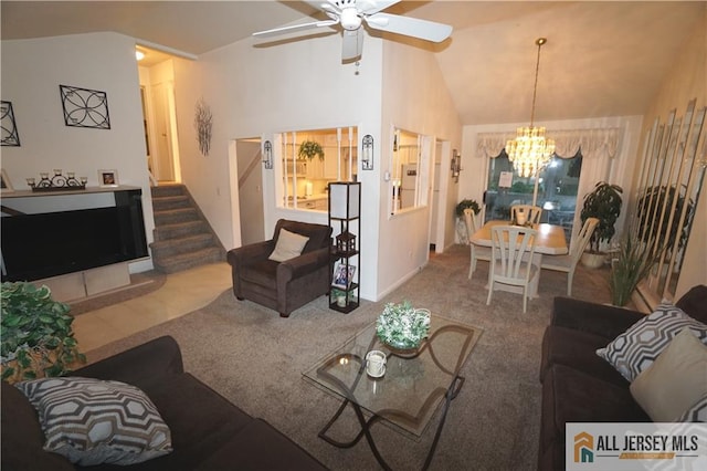 living room with ceiling fan with notable chandelier, carpet, and high vaulted ceiling