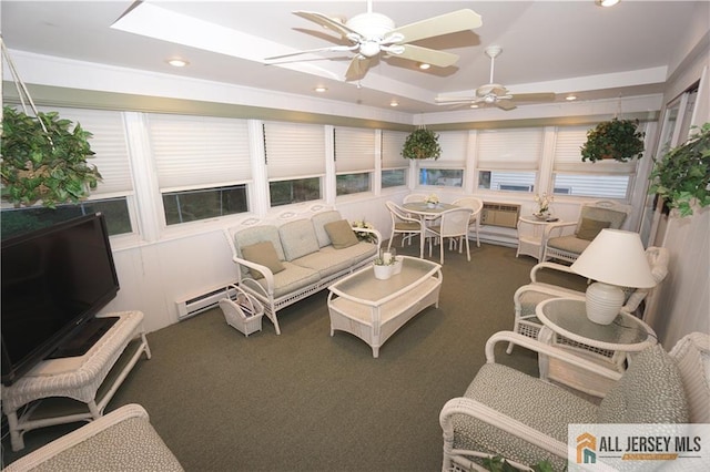 carpeted living room featuring a raised ceiling, a baseboard heating unit, and ceiling fan