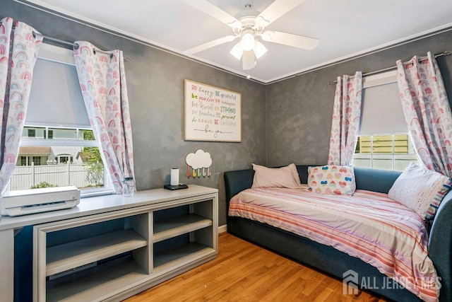 bedroom with ceiling fan and wood finished floors