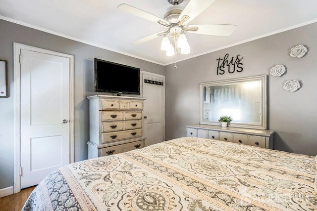bedroom featuring ornamental molding, ceiling fan, and wood finished floors
