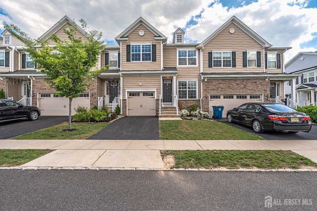 22 Larkspur Ln, Monroe, NJ 08831 - townhome / multi-family property with asphalt driveway, a garage, and a front yard