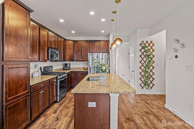 22 Larkspur Ln, Monroe, NJ 08831 - kitchen featuring stainless steel appliances, dark wood-style flooring, recessed lighting, a center island with sink, and light stone countertops