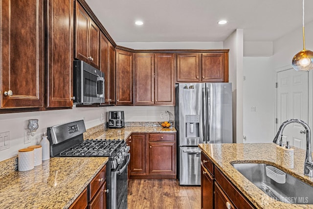 22 Larkspur Ln, Monroe, NJ 08831 - kitchen featuring appliances with stainless steel finishes, light stone countertops, wood finished floors, decorative light fixtures, and recessed lighting