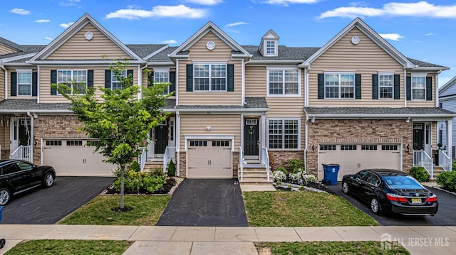 22 Larkspur Ln, Monroe, NJ 08831 - townhome / multi-family property featuring a garage, driveway, and stone siding