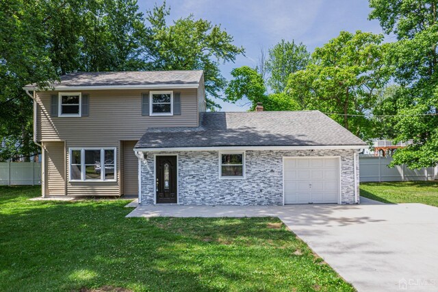 view of front property featuring a front lawn and a garage