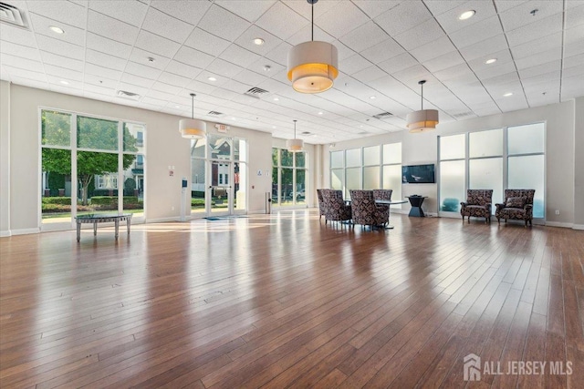 exercise room with plenty of natural light, baseboards, wood finished floors, and recessed lighting