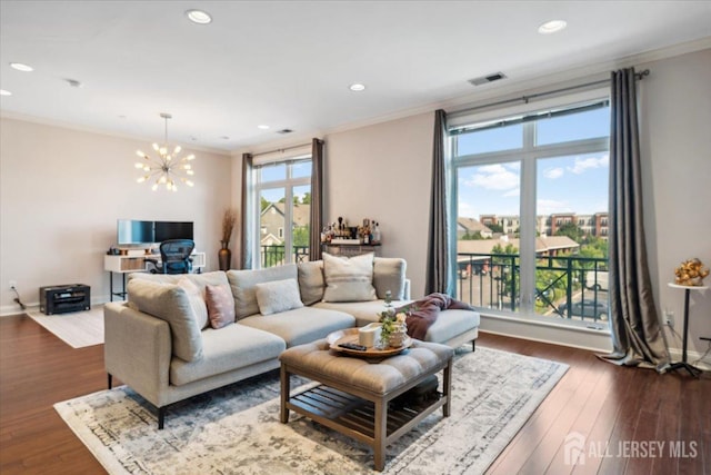 living room with crown molding, a chandelier, dark wood-style flooring, recessed lighting, and baseboards