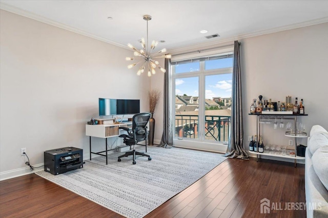 office featuring wood finished floors, a chandelier, crown molding, a bar, and baseboards