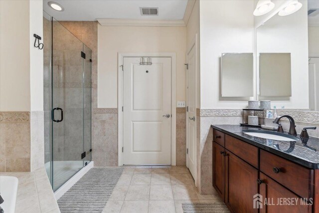 2 N Commerce Sq Unit 204, Robbinsville, NJ 08691 - full bathroom featuring tile walls, a shower stall, a wainscoted wall, crown molding, and tile patterned flooring