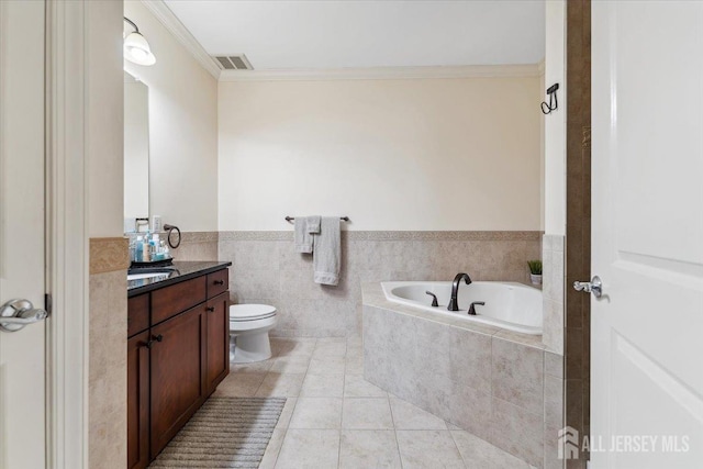 full bath with vanity, a garden tub, crown molding, a wainscoted wall, and tile patterned flooring