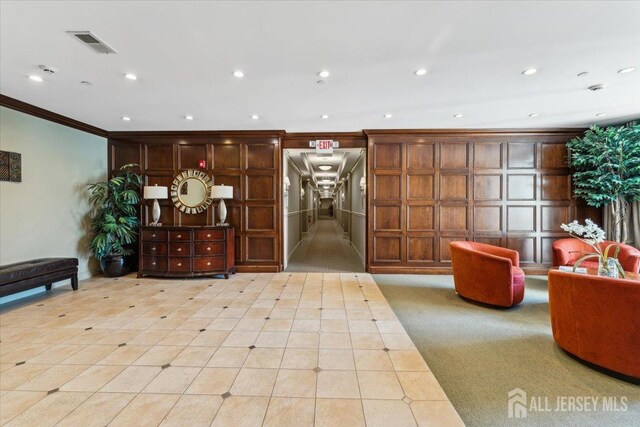 community lobby featuring crown molding and recessed lighting