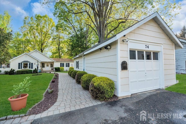 74 Ravine Dr, Matawan, NJ 07747 - view of front of house featuring a front yard and an outbuilding