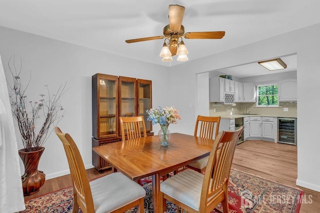 74 Ravine Dr, Matawan, NJ 07747 - dining room featuring wine cooler, light wood-type flooring, and a ceiling fan