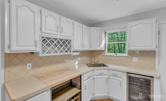74 Ravine Dr, Matawan, NJ 07747 - kitchen featuring beverage cooler, white cabinetry, and light countertops