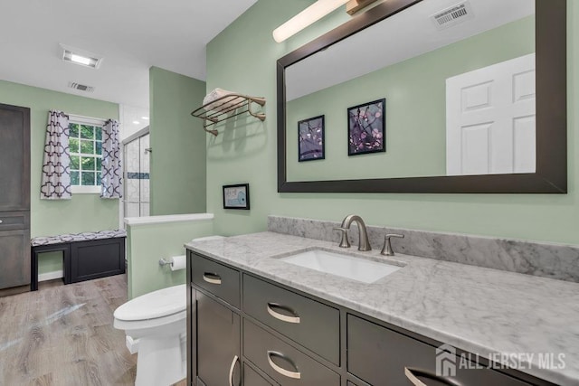 74 Ravine Dr, Matawan, NJ 07747 - bathroom featuring vanity, a stall shower, and wood finished floors