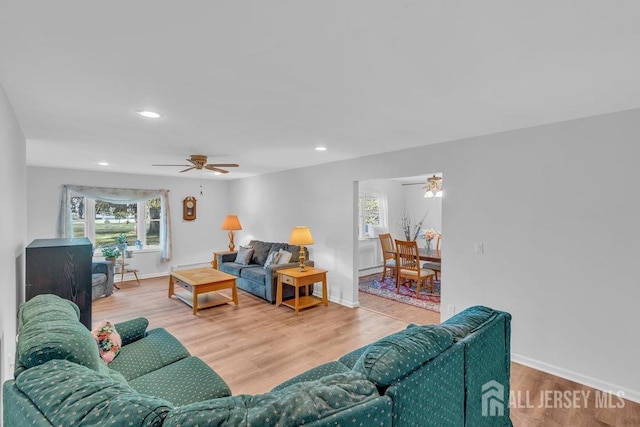 74 Ravine Dr, Matawan, NJ 07747 - living room with a ceiling fan, plenty of natural light, recessed lighting, wood finished floors, and a baseboard heating unit