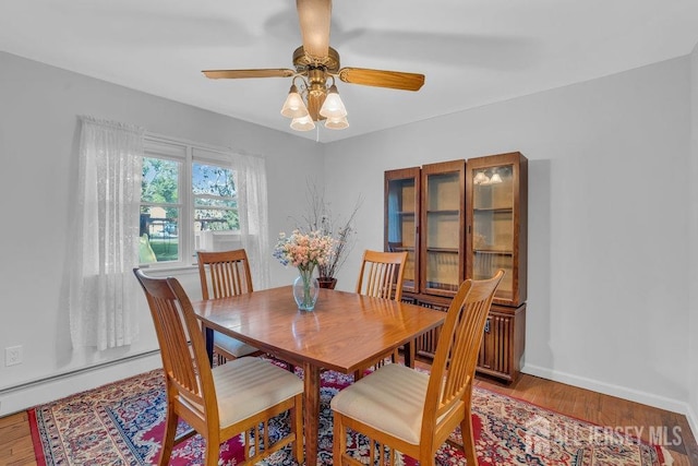 74 Ravine Dr, Matawan, NJ 07747 - dining room featuring a baseboard radiator, ceiling fan, and wood finished floors