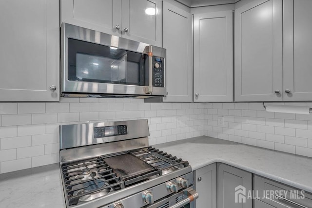 74 Ravine Dr, Matawan, NJ 07747 - kitchen with stainless steel appliances, gray cabinetry, and tasteful backsplash