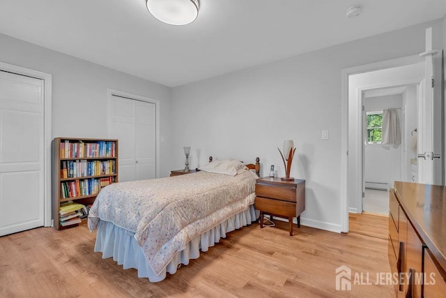 74 Ravine Dr, Matawan, NJ 07747 - bedroom with light wood finished floors and a baseboard heating unit
