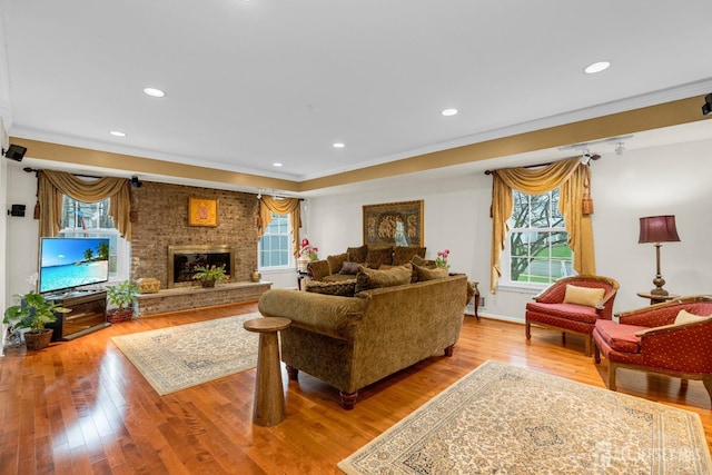 living room with plenty of natural light, wood finished floors, and recessed lighting