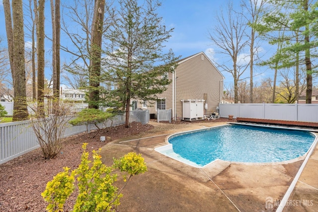 view of swimming pool with a fenced backyard, a patio, a fenced in pool, and cooling unit