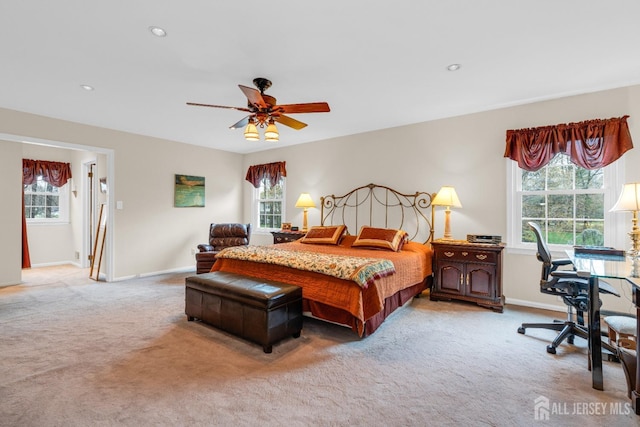 bedroom featuring multiple windows and light colored carpet