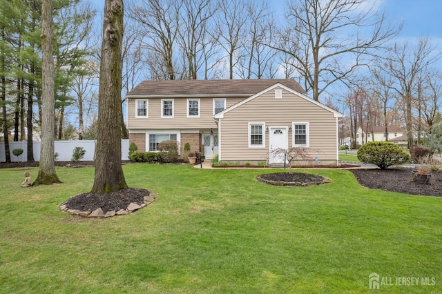 traditional-style home with fence and a front yard